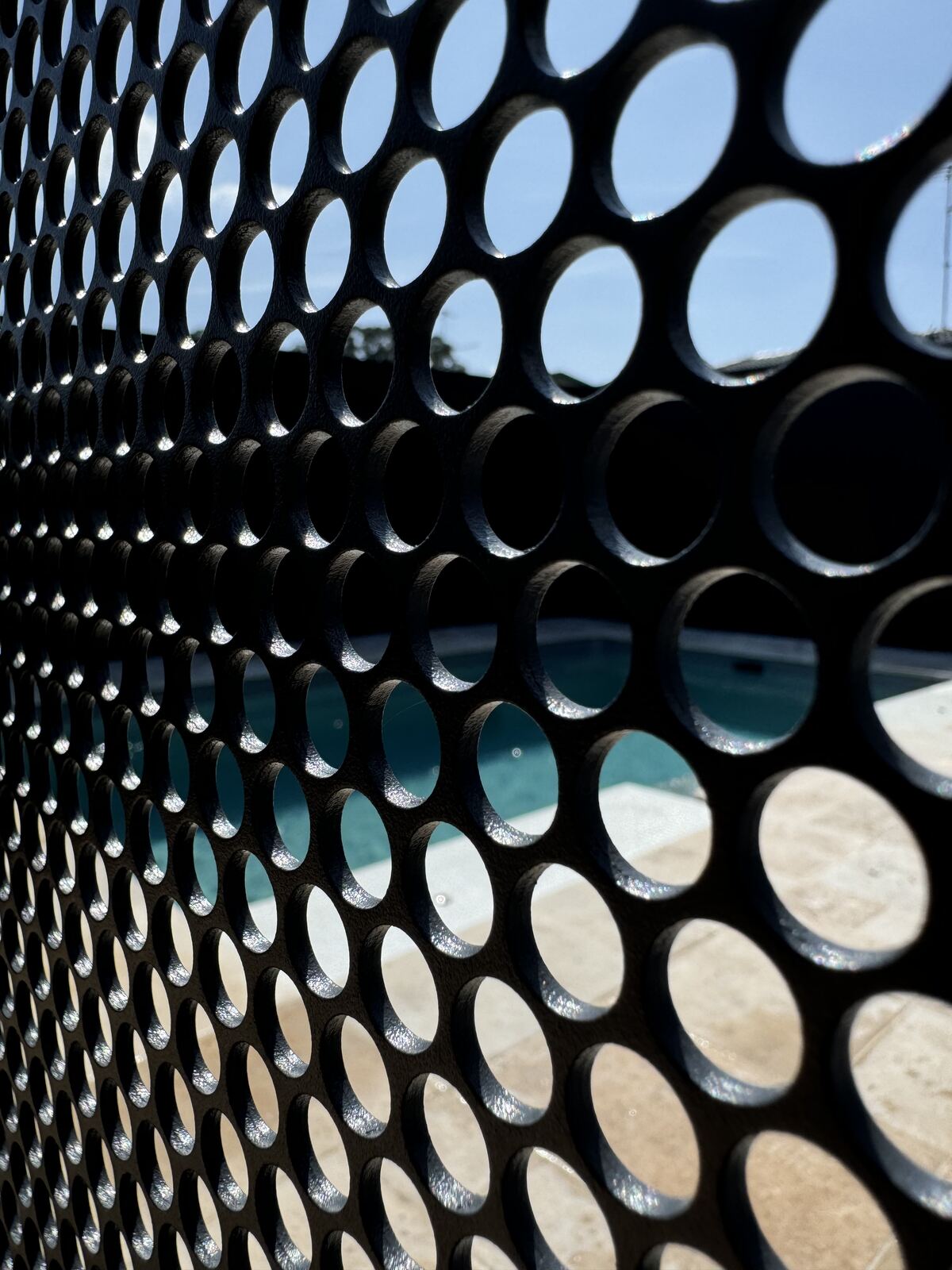 Close-up of Pool Perf perforated aluminium panel in Textured Ironstone