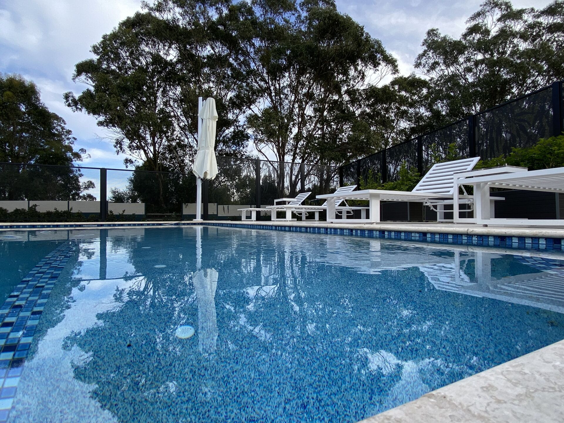 Pure Perf pool fencing in Textured Black beside a resort-style swimming pool, NSW